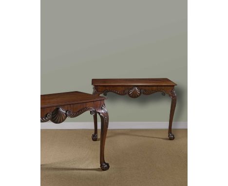 A FINE PAIR OF GEORGE II IRISH MAHOGANY CONSOLE TABLES C.1750each with a moulded edge top above a frieze centered with a shel