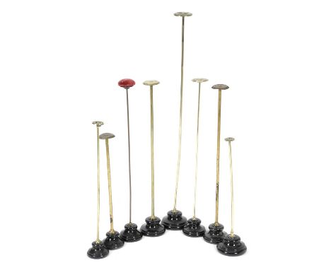 A COLLECTION OF EIGHT BRASS HAT OR SCARF STANDSEARLY 20TH CENTURYof various heights, on black glazed ceramic bases (8)107cm (