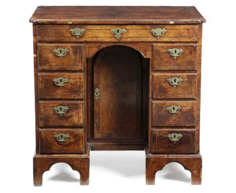 A GEORGE II WALNUT KNEEHOLE DESKC.1735inlaid with stringing and crossbanding, the quarter veneered top with a caddy moulded e