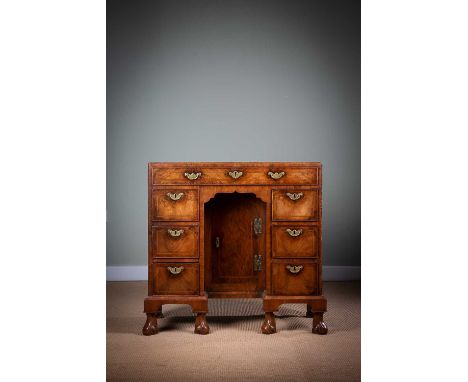A FINE GEORGE II WALNUT KNEEHOLE DESK / DRESSING TABLEC.1730with feather and cross banding, the top with a caddy moulded edge