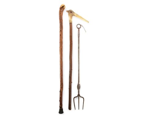 A STEEL TOASTING FORK18TH CENTURYwith a ring finial, together with a folk art walking stick with a bone handle in the form of