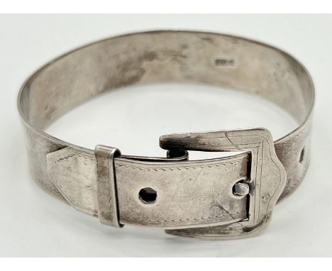 A vintage silver adjusting buckle bangle with delicate scallop engraving to both edges and 3 adjusting holes. Silver marks to