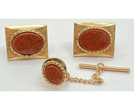 A vintage pair of goldtone cufflinks set with ovals of brown goldstone, together with a matching tie stud with button hole T 