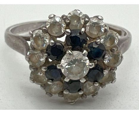 A vintage silver, sapphire and cubic zirconia cluster dress ring. Hallmarked and stamped CZ inside band, ring size MÂ½, mount