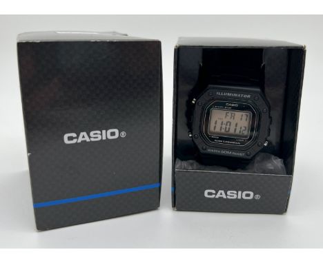A boxed Casio Illuminator W-218H digital wristwatch with hard plastic case and rubber strap. With date and alarm function. Co