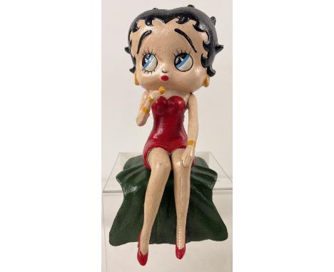 A painted cast iron shelf figure of Betty Boop singing. Approx. 26cm long and weighs 2.75kg. 