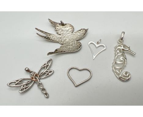 5 silver and white metal pendants. To include hammered effect bird, Celtic design dragonfly and pierced work seahorse. Larges