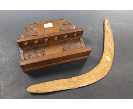 A CARVED CHINESE WOOD FOLDING PIPE RACK TOGETHER WITH A BOOMERANG 