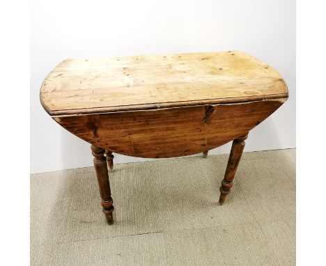 A large vintage pine drop leaf table, extended 110 x 107 x 72cm. A/F as pull out missing from one side.