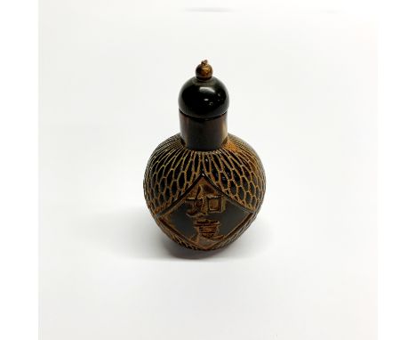 A Chinese carved cattle horn snuff bottle, H. 8cm.