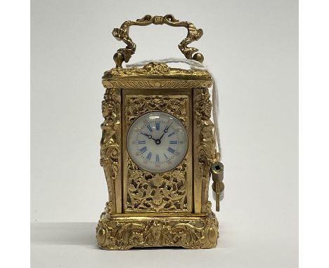 An ornate miniature gilt brass carriage clock, H. 8.5cm.