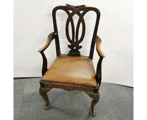 A Georgian style carved oak elbow chair with tan leather re-upholstered seat, H. 99cm.