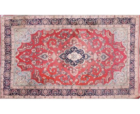 A large eastern style red ground rug, 306 x 204cm with a further red rug.