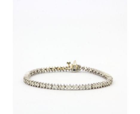 A 14ct white gold diamond set tennis bracelet, L. 16.5cm.