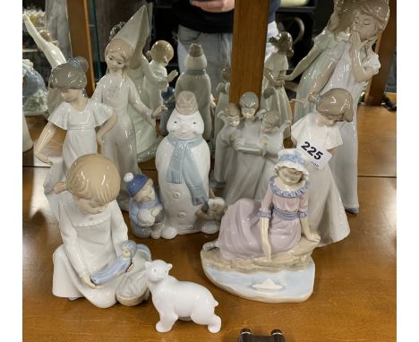 A group of nine Nao figurines, tallest 29cm.