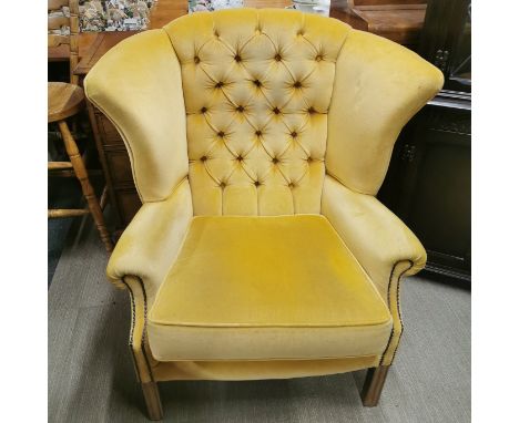 A wingback chesterfield armchair, H. 102cm.