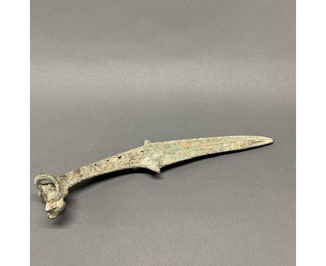 A Chinese bronze dagger with open work handle in the form of a bulls head. Prov. N. Forbes collection. Purchased from Parthen