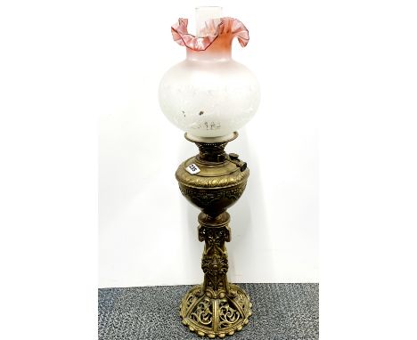 An Art Nouveau brass oil lamp with frosted glass shade, H. 73cm.