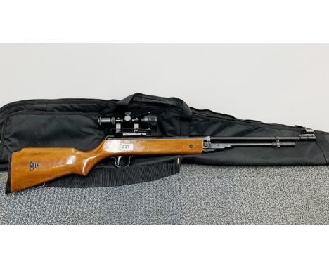 An air rifle with telescopic sight and canvas case.