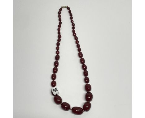 A graduated faux cherry amber necklace, L. 68cm.