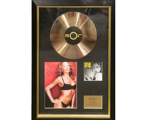 Autograph interest. A framed signed photograph of Kylie Minogue and gold disc for 'Kylie Greatest Hits 87-99' frame 78 x 54cm