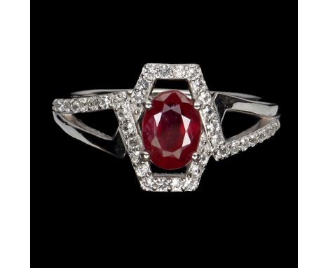 A 925 silver ring set with an oval cut ruby and white stones, ring size O.5.