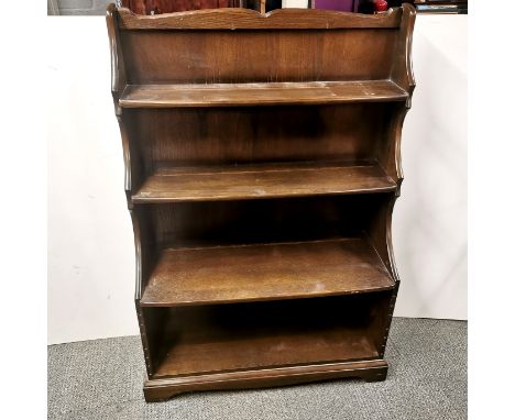 An Ercol dark elm waterfall bookshelf, H. 127cm W. 87cm D. 33cm. (Design 983)