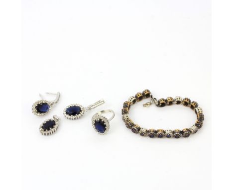 A 925 silver sapphire set bracelet together with a suite of 925 silver sapphire set pendant, ring and earrings.