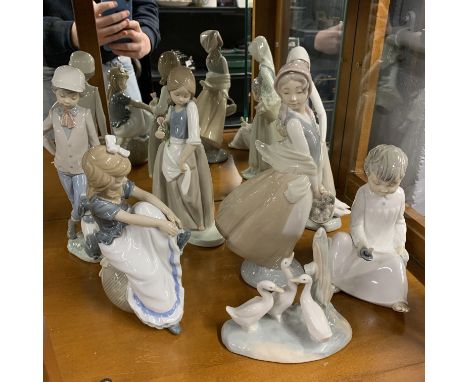 A group of seven Nao and other porcelain figurines, tallest 28cm.