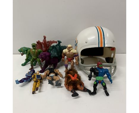 A collection of vintage action figures, together with a childs Miami Dolphin American football helmet.