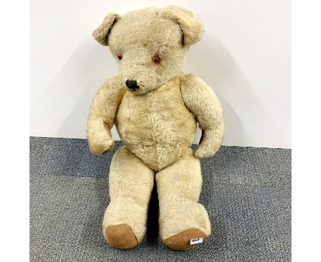 A large vintage straw filled articulated plush teddy bear, H. 75cm.