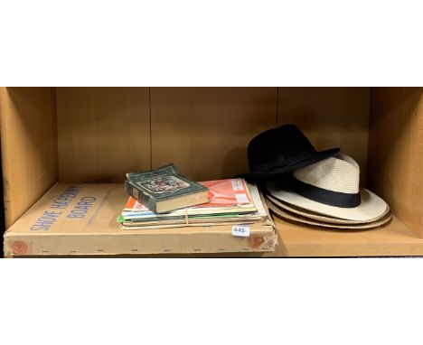 A boxed shove Ha'penny board with a quantity of sheet music and gentlemens hats.