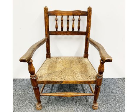 A 19thC elm rush seat nursing chair, H. 76cm.