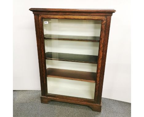 An oak 1930's glazed front bookcase, 108 x 75 x 30cm.