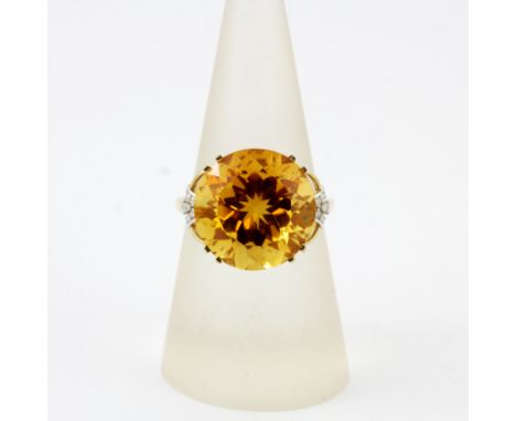 A hallmarked 9ct yellow gold ring set with a large round cut citrine and diamonds, (O.5).