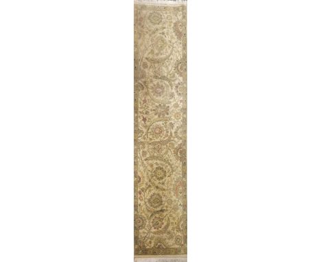 A beige ground eastern style runner, 315 x 80cm.