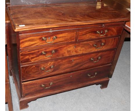 A George III mahogany four height chest of drawers of small proportions, fitted with a dressing slide Natural veneer cracks, 