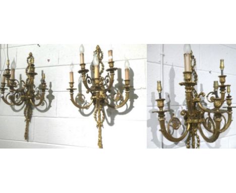 A set of four gilt metal five-light wall sconces 