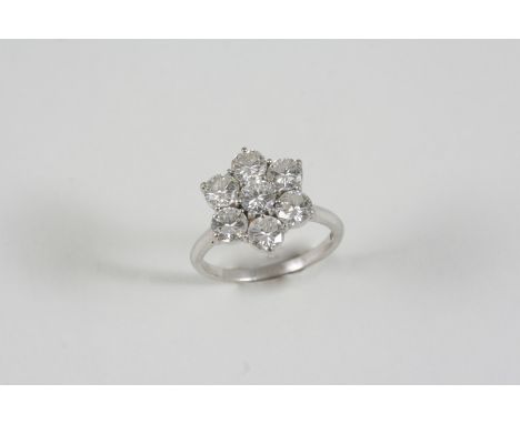 A DIAMOND CLUSTER RING the flowerhead design is set with brilliant-cut diamonds in 18ct. white gold. Size R.