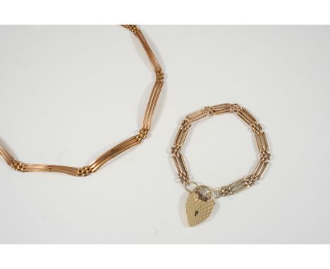 A 9CT. GOLD GATE LINK BRACELET with padlock clasp, 17cm. long, 14.5 grams, together with a gold gate link necklace, 33cm. lon