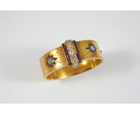 A VICTORIAN DIAMOND, ENAMEL AND GOLD HINGED BANGLE the centre section set with seven cushion-shaped diamonds, within a blue e