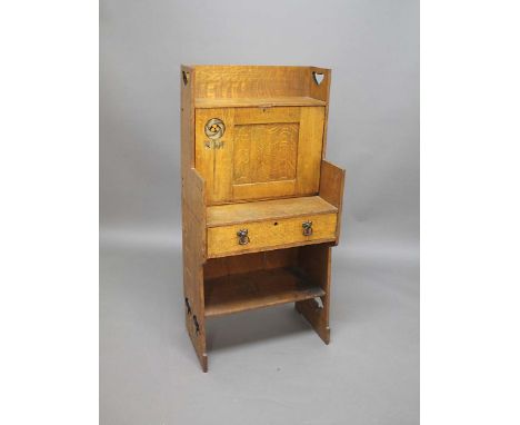 ARTS & CRAFTS OAK BUREAU the oak bureau with a drop down front to reveal interior pigeon holes, the door with a stylised flor