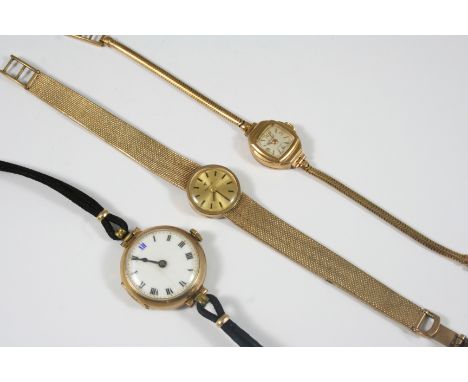 A LADY'S 9CT. GOLD WRISTWATCH BY TISSOT the signed circular dial with baton numerals, winder missing, on an integrated gold m