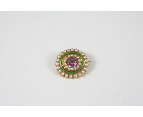AN EARLY 20TH CENTURY ENAMEL, PEARL AND GEM SET BROOCH centred with an amethyst within a surround of half pearls and of green