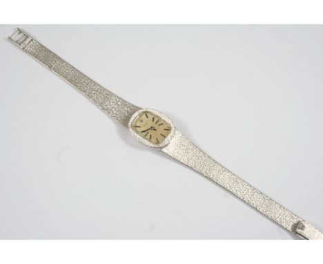 A LADY'S 18CT. WHITE GOLD WRISTWATCH BY ROLEX the signed oval-shaped dial with baton numerals, on an integrated mesh bracelet