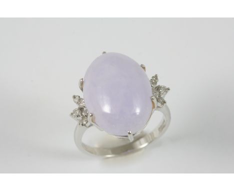 A LILAC JADE AND DIAMOND RING the oval lilac jade cabochon is set with circular-cut diamonds to each shoulder, in 18ct. white