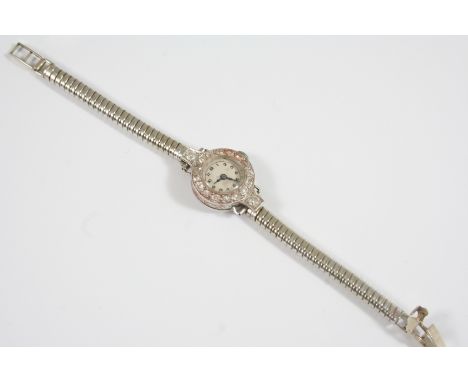 A LADY'S DIAMOND COCKTAIL WRISTWATCH the white circular dial with Arabic numerals and circular-cut diamonds set to the bezel,