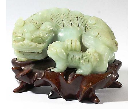 CHINESE CELADON NEPHRITE JADE FEMALE GUARDIAN LION, carved resting a paw on her puppy, on a hardwood stand, length 10cm