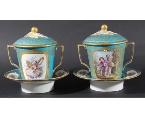 PAIR OF SEVRES TWO HANDLED CUPS, COVERS AND TREMBLEUSE SAUCERS, early 19th century, painted with romantic scenes inside jewel