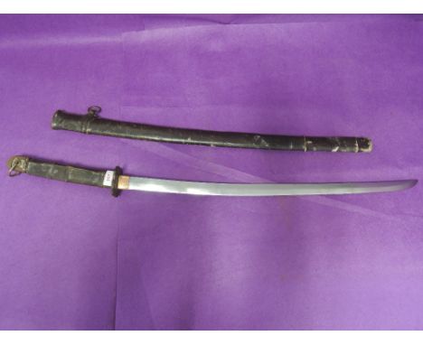 A World War II Japanese sword (katana) in scabbard encased in leather field service cover. Sword handle also leather covered,